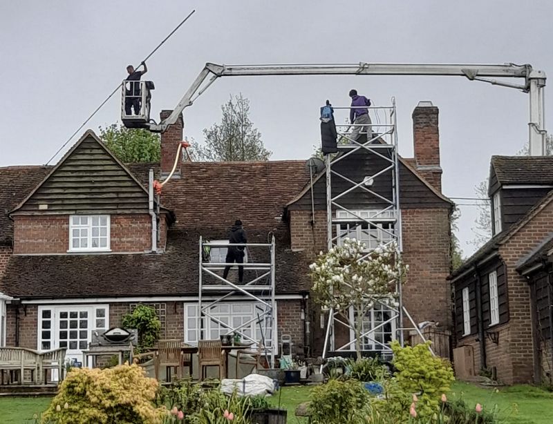 The Moss Cleaners using cherry picker and scaffolding to clean roof safely and professionally in Sidcup, {{COUNTY}}